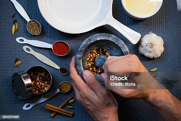 One Man Grinding Spices Stock Photo - Download Image Now - Mortar and Pestle, Spice, Grinding