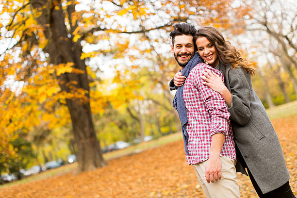 istock Young couple in the autumn park 584505238