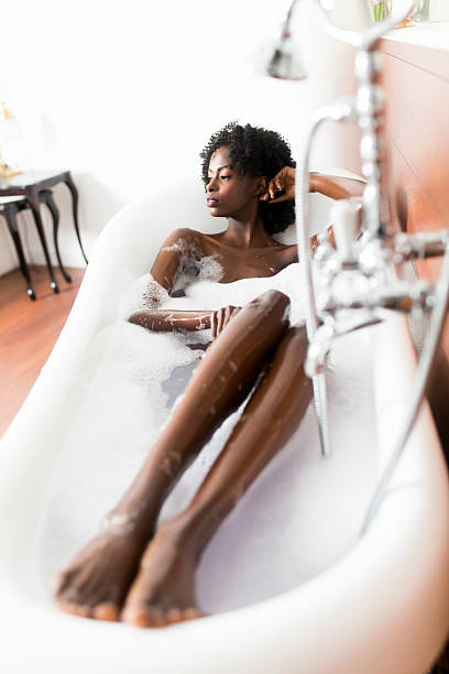 istock Young black woman in the bath 584505364