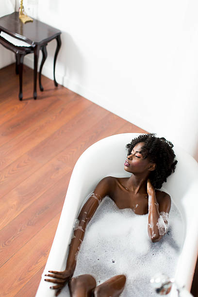 istock Pretty black woman having a bath 584505384