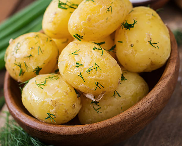 istock Boiled new potatoes seasoned with dill and butter 584506852