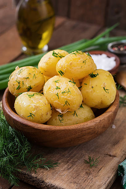 istock Boiled new potatoes seasoned with dill and butter 584507132