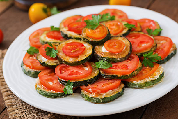istock Dish with a snack of fried zucchini with tomatoes 584507832