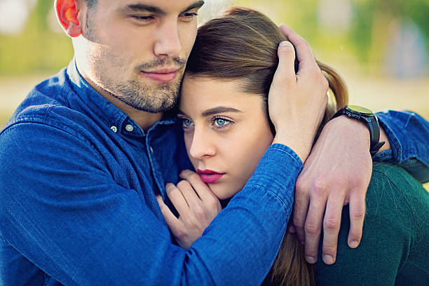 istock Boy hugging his sad girlfriend in the park 584510806