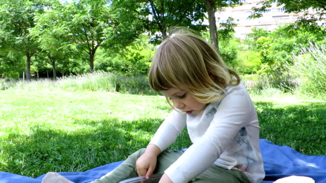 baby eating sitting in park