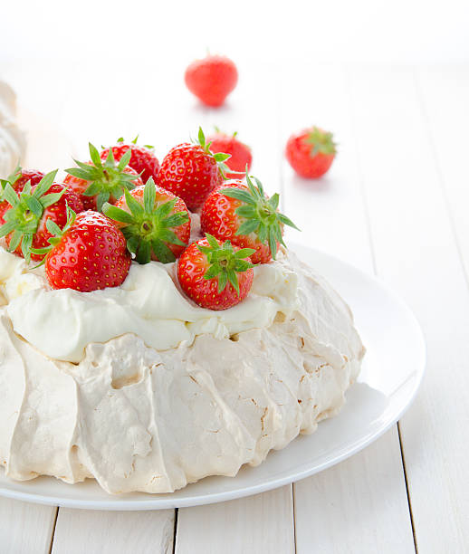 istock Pavlova cake with strawberry on white rustic background. 584568636