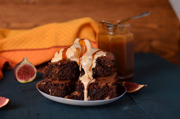 istock Brownie with walnuts, salted caramel, figs on a dark blue 584569016