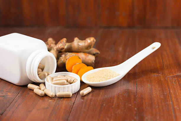 istock Turmeric herbal capsules in white bottle 584575888