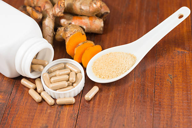 istock Turmeric herbal capsules in white bottle 584576056