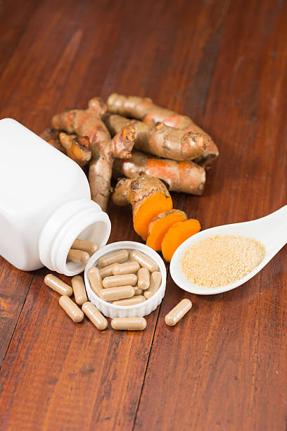 istock Turmeric herbal capsules in white bottle 584576446
