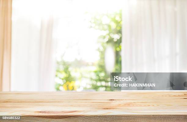 Wood Table Top On Blur Curtain Window With Green Garden Stock Photo - Download Image Now