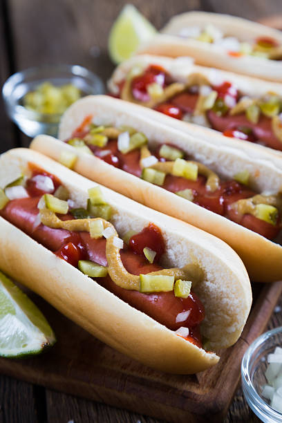 istock Hot dogs with onions and pickles 584581046