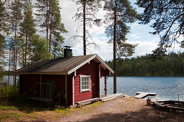 Typical Lakeside Sauna in Finland Kuhmo District, Finland - July 20, 2016: A typical sauna hut at an outdoor activity area by a lake in Finland, with a jetty and picnic area.  The sauna is an integral part of Finnish culture - there are 3 million saunas in Finland, an average of one per household, and the sauna seen as a necessity and an important part of the national identity. finnish culture stock pictures, royalty-free photos & images