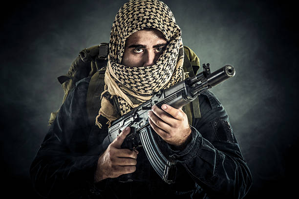 Terrorist Unrecognizable terrorist armed with an AK-74 assault rifle. Unrecognizable Middle Eastern man in camouflage. guerrilla warfare photos stock pictures, royalty-free photos & images