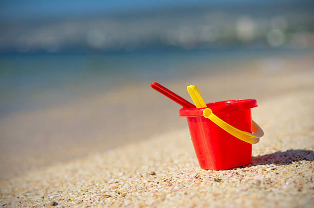 istock Baby bucket on sand 584587846