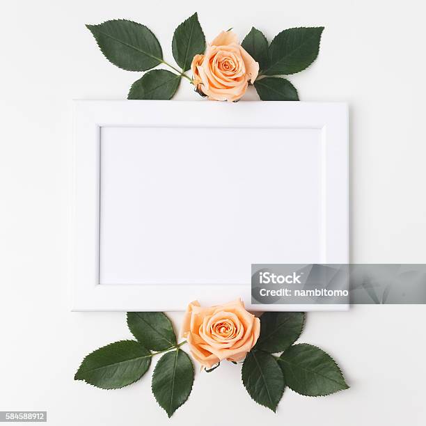 Decorative Frame With Orange Roses And Green Leaves Flat Lay Stock Photo - Download Image Now