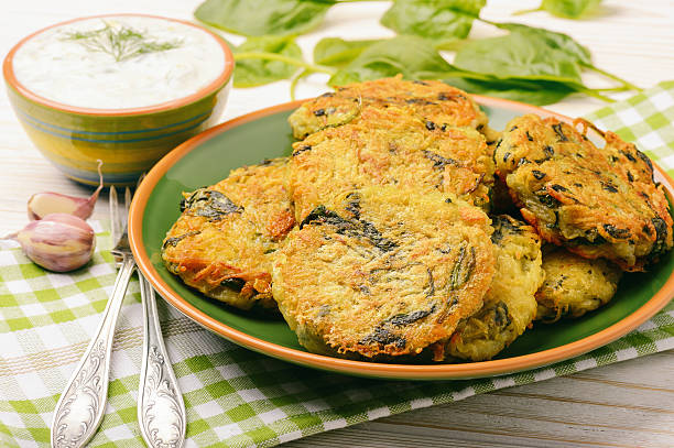 istock Vegetarian cuisine - fritters with potatoes and spinach. 584588954