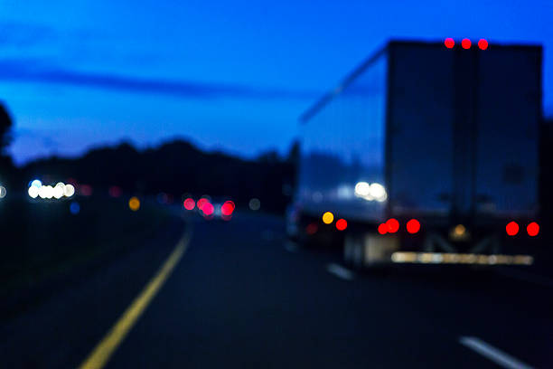 istock Night Expressway Abstract Lights And Speeding Semi Trailer Truck 584590094