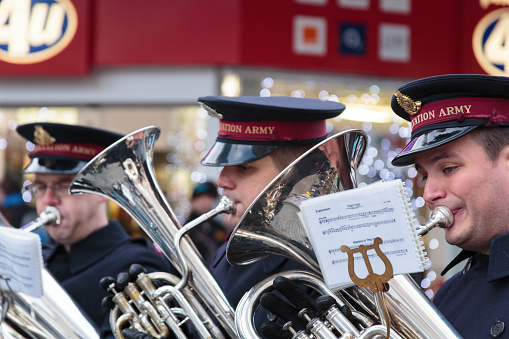 Birmingham, United Kingdom - December 15, 2012: Close up showing three members of the Salvation Army brass band playing on High Street in Birmingham city centre