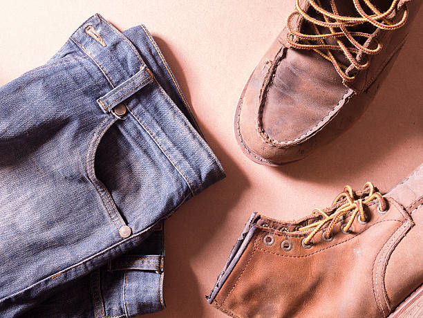 istock blue jean with still life of old leather boots, 584590612