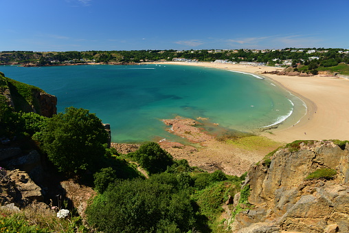 Wide angle image of a popular bay with tourism.