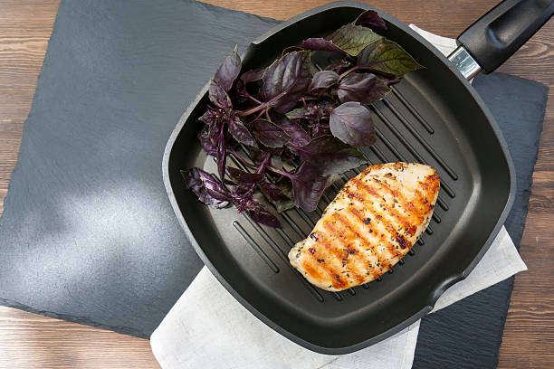 istock Grilled chicken breast steak with violet basil 584592006