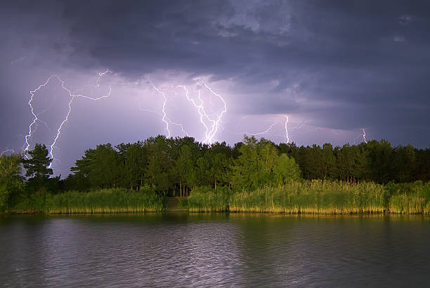 lightning on the river. - storm summer forest cloudscape imagens e fotografias de stock