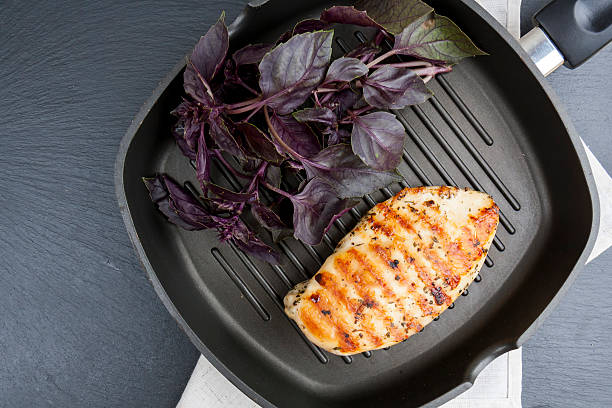istock Grilled chicken breast steak with violet basil 584592070