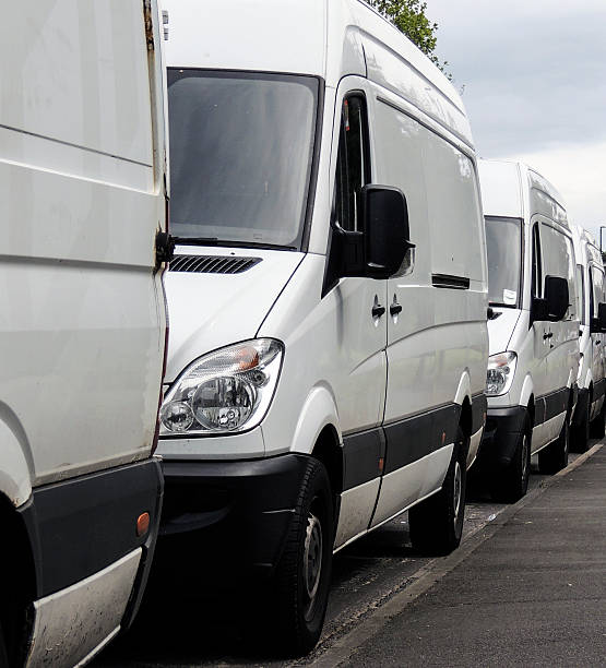 istock Logistics - transportation - row of vans 584592532