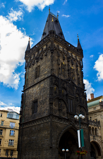 The Powder Tower is one of the original 13 city gates in Old Town, Prague, Construction began in 1475. The tower was intended to be an attractive entrance into the city, instead of a defensive tower. The foundation stone was placed by Vladislav II. The city council gave Vladislav II the tower as a coronation gift. While it was being built, it was called the New Tower. The look of the tower was inspired by the work of Peter Parler on the Charles Bridge. Vertical composition.