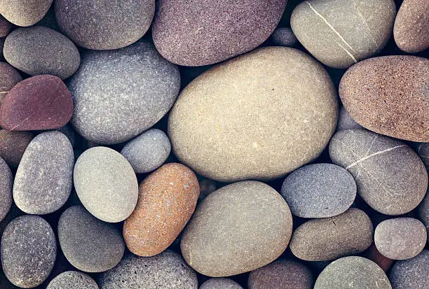 Photo of abstract background with dry round pebble stones macro