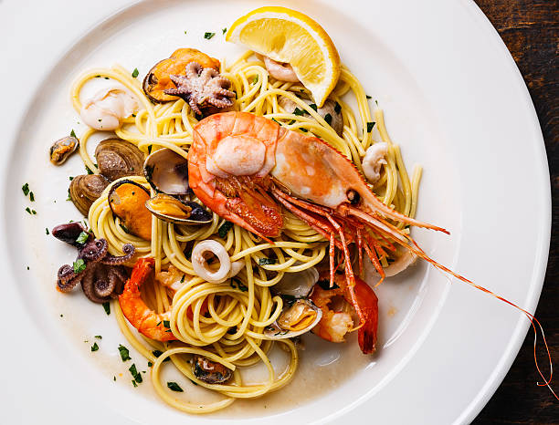 istock Spaghetti with Clams, Prawns, Seafood Cocktail close up 584594522