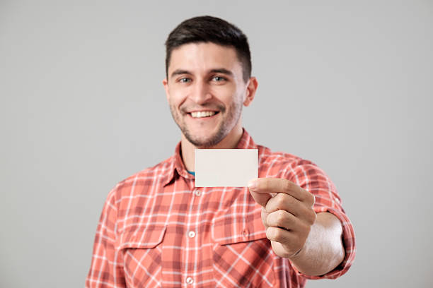 istock Man showing blank business card 584594848