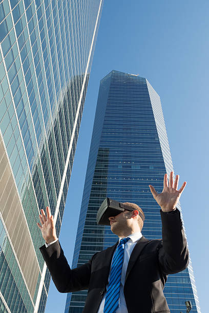 istock Businessman using virtual reality glasses in a business center 584596138