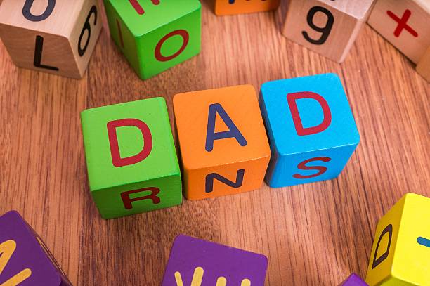 istock Dad word written with colorful cubes with letters. 584597310
