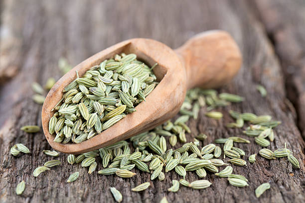 istock fennel seed in a wooden scoop on table 584597502