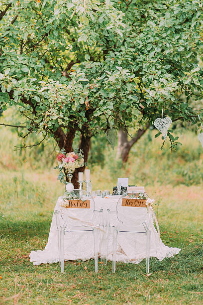 Wedding decoration in forest. Rustic ceremony in park, table andchairs