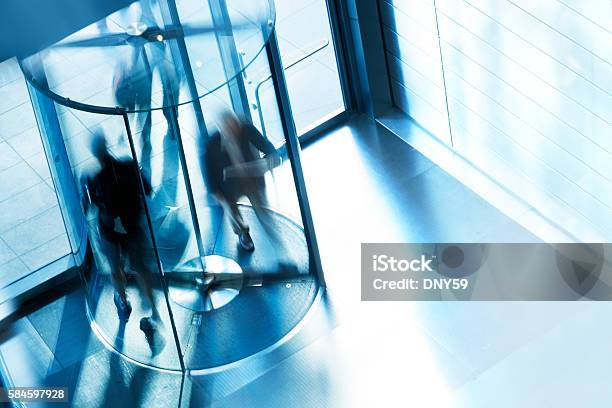 Revolving Door At Entrance To Office Building Stock Photo - Download Image Now - Revolving Door, People, Business Person