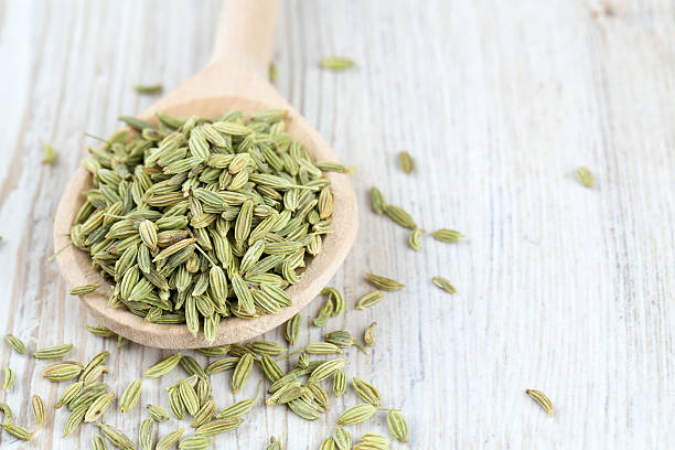 istock fennel seed in a wooden spoon on table 584597980