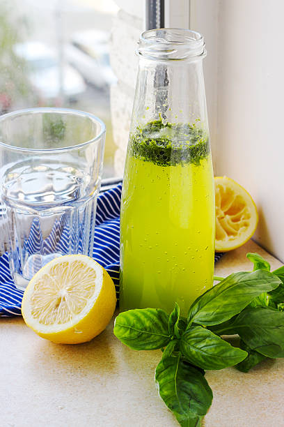 istock Summer drink with lemon, basil and soda 584599282