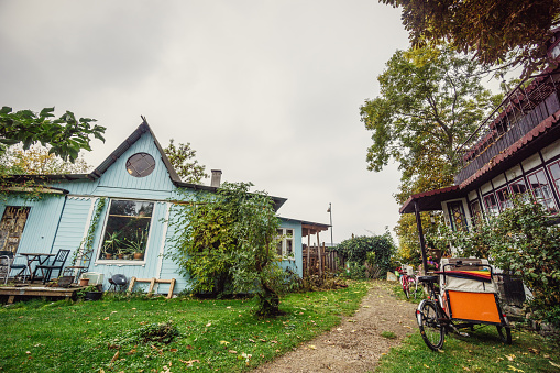 Freetown Christiania Copenhagen, Denmark - October 18, 2015: Street scene at the autonomous Freetown Christiana, in Christianshavn neighbourhood. A few houses and a bicycle are visible in the image.