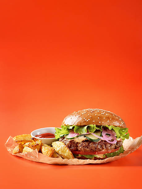 istock Burger, mexican potatoes and ketchup on kraft paper 584606298