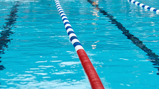 Swimming pool with lane markings and floating divider at a swim meet.