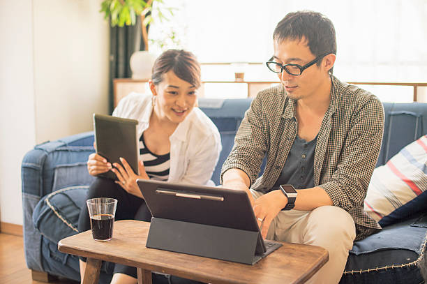 istock Mid adult man using digital tablet at home 584607394