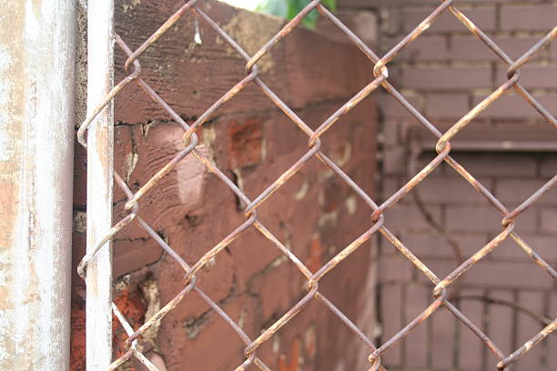 istock Chain Link Fence and Brick Wall 584612320