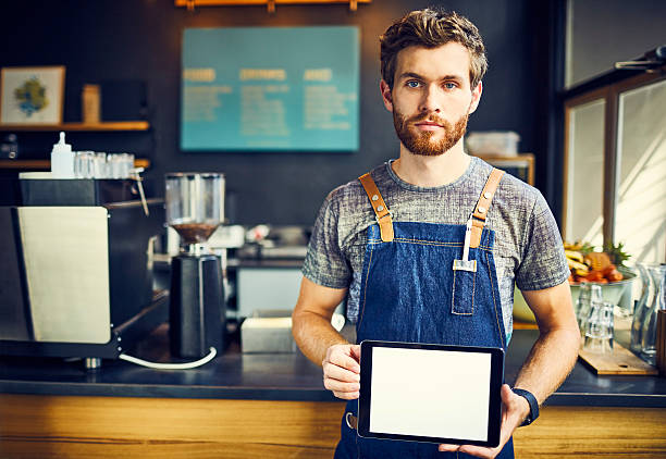 istock Barista holding digital tablet with blank screen 584612784