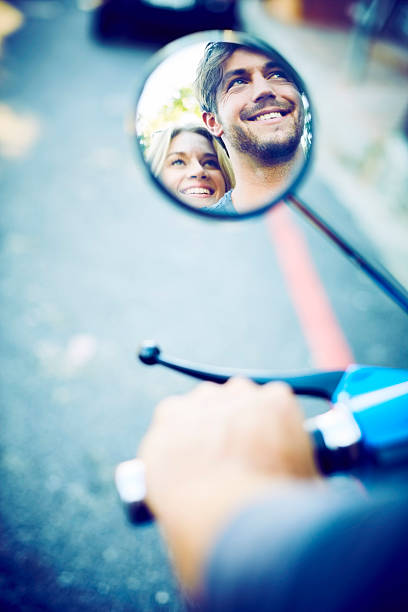 istock Reflection of smiling couple on vehicle mirror 584612842