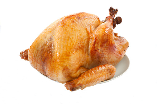 Mouth-watering golden roasted turkey over white background, no garnish.