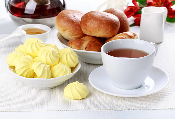 istock Tea party with meringue cookies and buns. 584613276