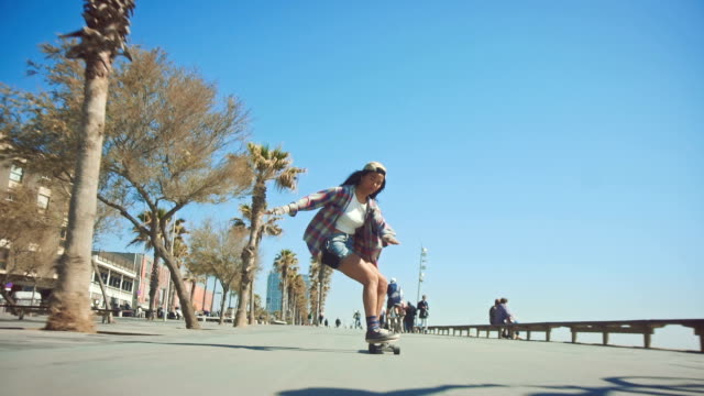 Woman skateboarding at beach